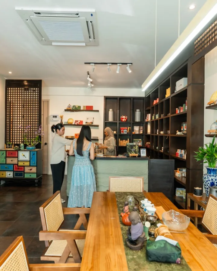 Inside the tea house: tasting table and tea shelves