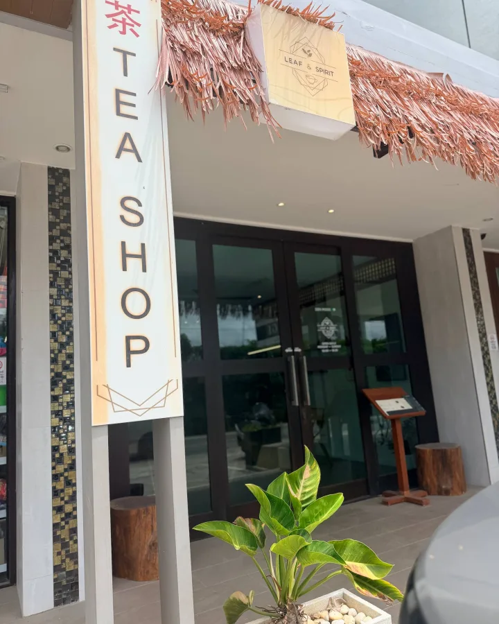 Street entrance of the Leaf & Spirit tea shop with the TEA SHOP sign